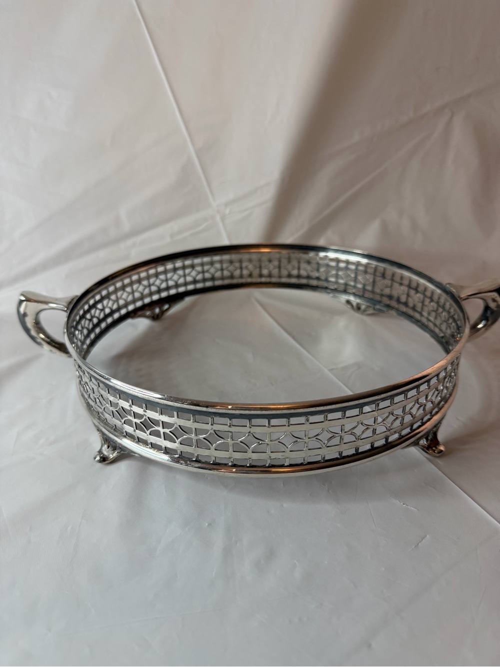 Vintage Silverplate pierced casserole holder with handles.